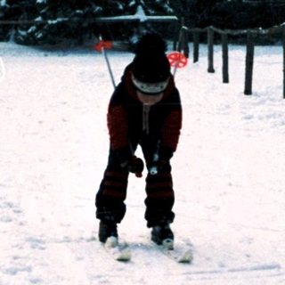 Person skiing down snow-covered slope.