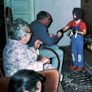 Family playing video game indoors together.