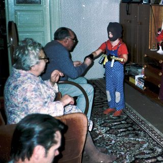 Family playing video game indoors together.