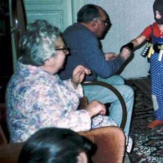 Family playing video game indoors together.