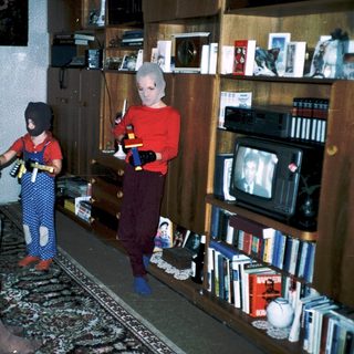 Family playing video game indoors together.