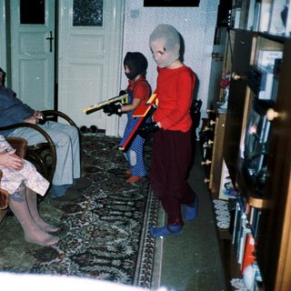 Family playing video game with retro controllers.