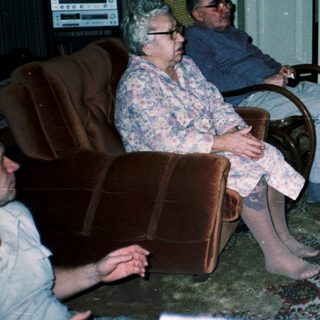 Family playing video game with retro controllers.