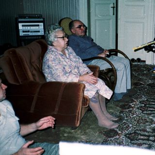 Family playing video game with retro controllers.