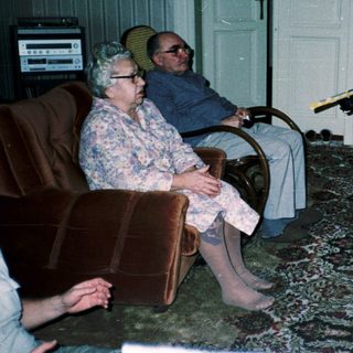 Family playing video game with retro controllers.