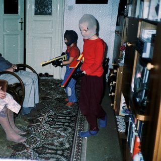 Family playing video game with retro controllers.