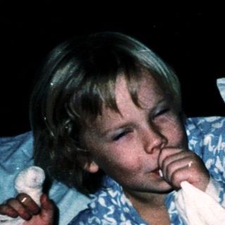Two children resting in bed together.