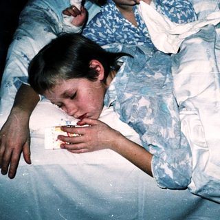 Two children resting in bed together.
