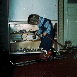 Child playing with toy cars indoors.