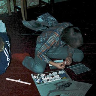 Two people assembling model kits indoors.