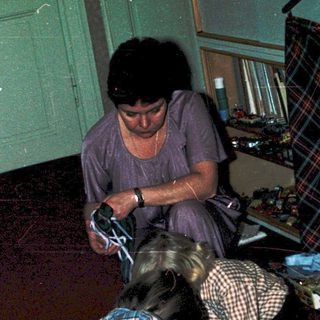 Two people organizing or sorting items on the floor.