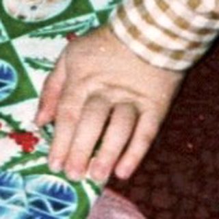 Person wrapping a gift on the floor.