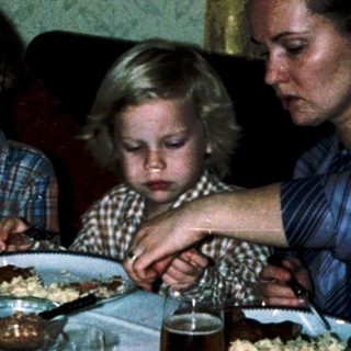 Family gathered around a table for a meal.