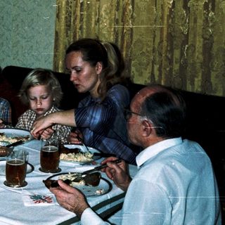 Family gathered around a table for a meal.