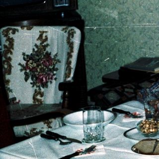 Family dining together indoors during evening meal.