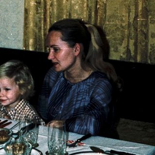 Family dining together indoors during evening meal.