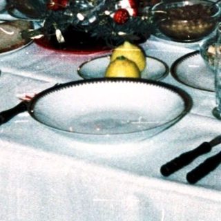 Family dining together indoors during evening meal.