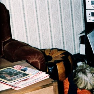 Two children examining a large map together indoors.