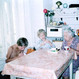Three generations sharing a meal indoors.