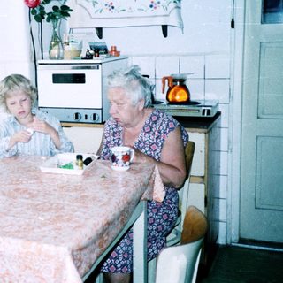 Three generations sharing a meal indoors.