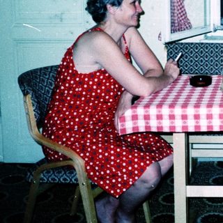 Three people enjoying a meal and drinks indoors.