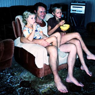 Family enjoying snack time indoors together.