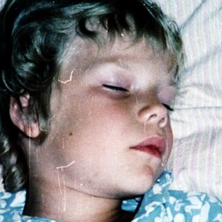 A child peacefully sleeping in bed.