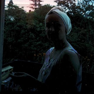 Person in traditional attire views pagoda at dusk.