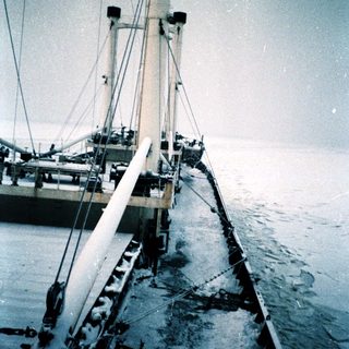 Docked sailboat with rigging at night.