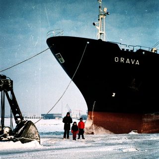 Icebreaker ship "Orava" navigating frozen waters with crew.