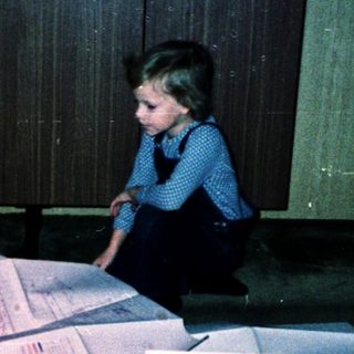 Family sorting or organizing paperwork together indoors.