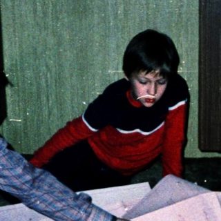 Family sorting or organizing paperwork together indoors.