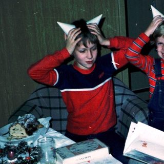 Family enjoying holiday with cat-ear headbands indoors.