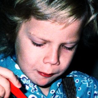 Child eating cereal with a spoon.