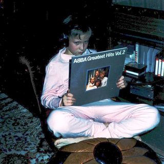 Person listening to ABBA Greatest Hits Vol. 2 album.