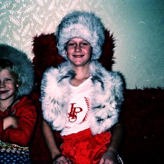 Two children dressed as Santa Claus.