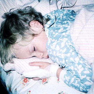 Child sleeping peacefully in bed.