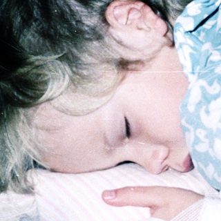 Child sleeping peacefully in bed.