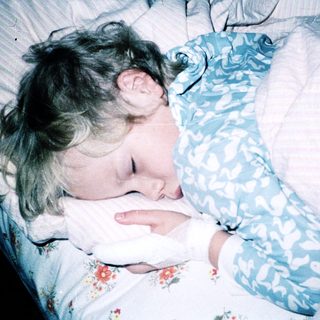 Child sleeping peacefully in bed.
