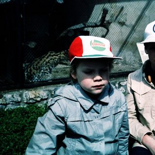 Two children wearing zoo or safari park hats.