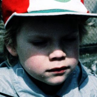 Two children wearing zoo or safari park hats.