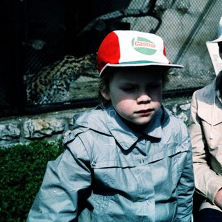 Two children wearing zoo or safari park hats.