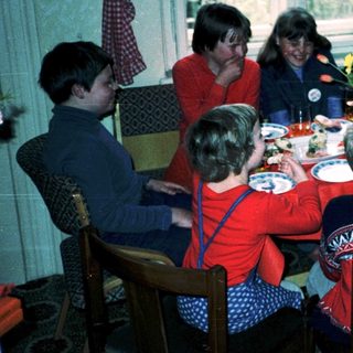 Family gathering around a festive dinner table.