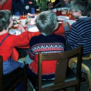 Family gathering around a festive dinner table.