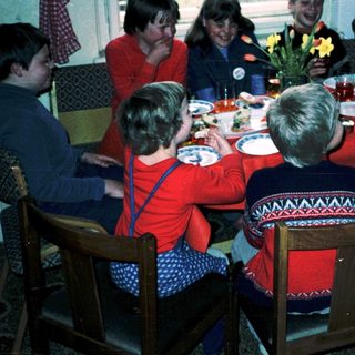 Family gathering around a festive dinner table.