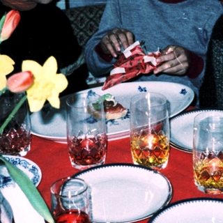 Group of children gathered around a table eating.
