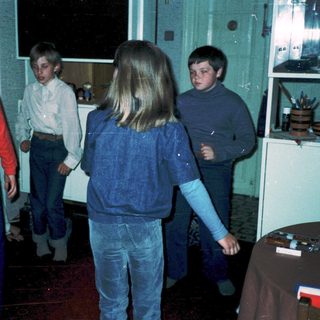Group of children playing indoors during evening.