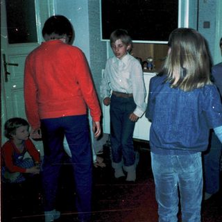 Group of children playing indoors during evening.
