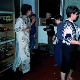 People playing arcade games in a retro bar.