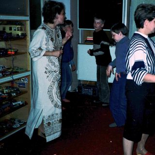 People playing arcade games in a retro bar.